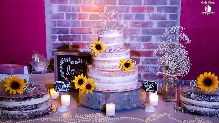 Wedding cake table with sunflowers against the brick at Depot Square Events