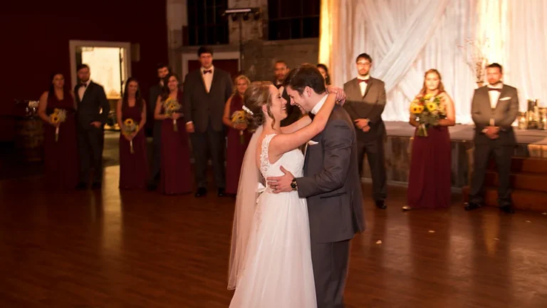 Couple dancing while the wedding party watches at the Gallatin venue