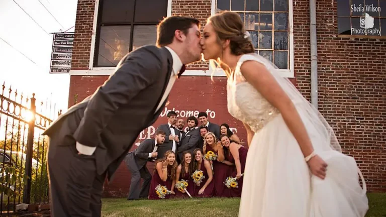 Newlyweds kiss outside the historic depot in Gallatin